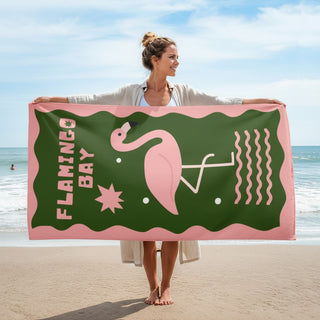 Woman holding a beach towel with a flamingo design on a beach, Flamingo Bay Beach Towel, Pink and Green, Flamingo print